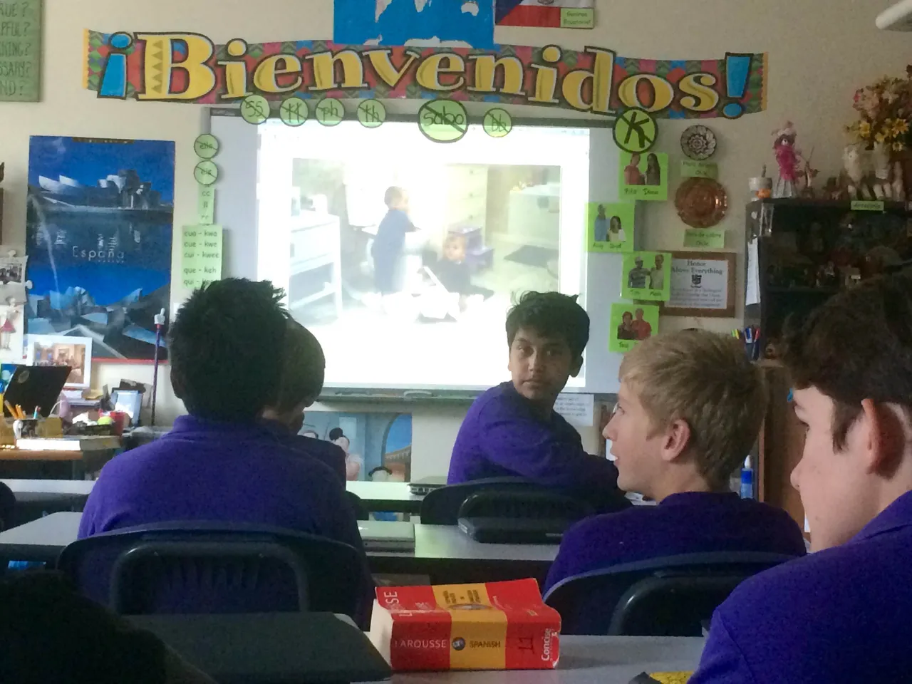 Sub-freshmen tell a story in Spanish based on a photograph shown on the SMART Board.