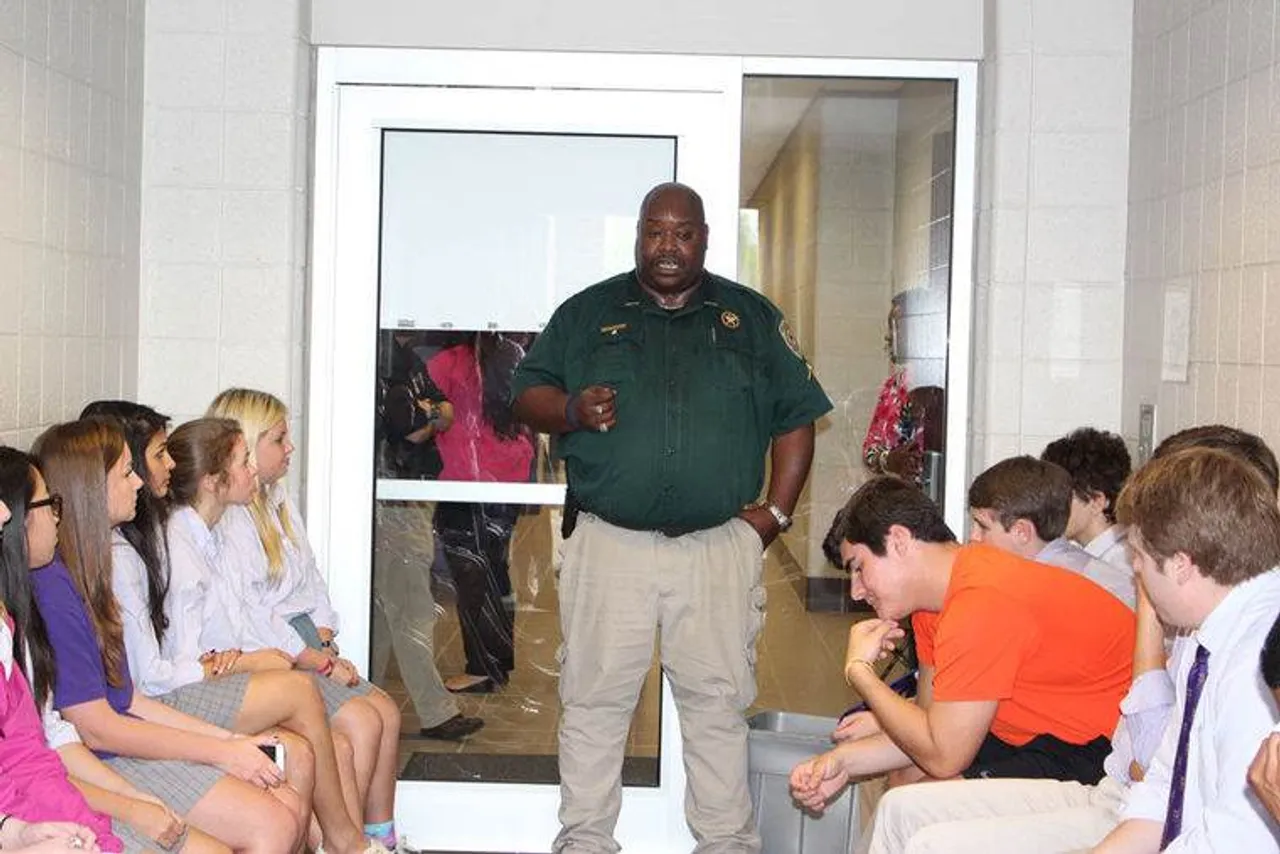 Senior Deputy Tony Boston talks to students from the "jail" during Darlington's Prom Promise. (Photo credit: Kristina Wilder / RN-T.com)