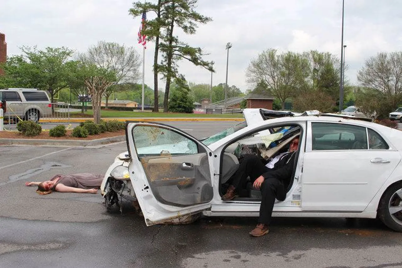 Ella Peek (left) and Brooks Busby pretend to be teens in a car crash on prom night during Darlington's Prom Promise event. (Photo credit: Kristina Wilder / RN-T.com)