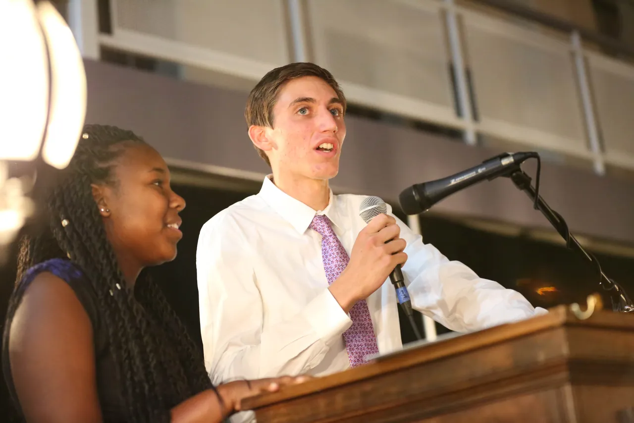Juniors Aaryn Ijames and Lawson Blake share plans for the renovation of The Growl during the Raise the Paddle portion of the evening.
