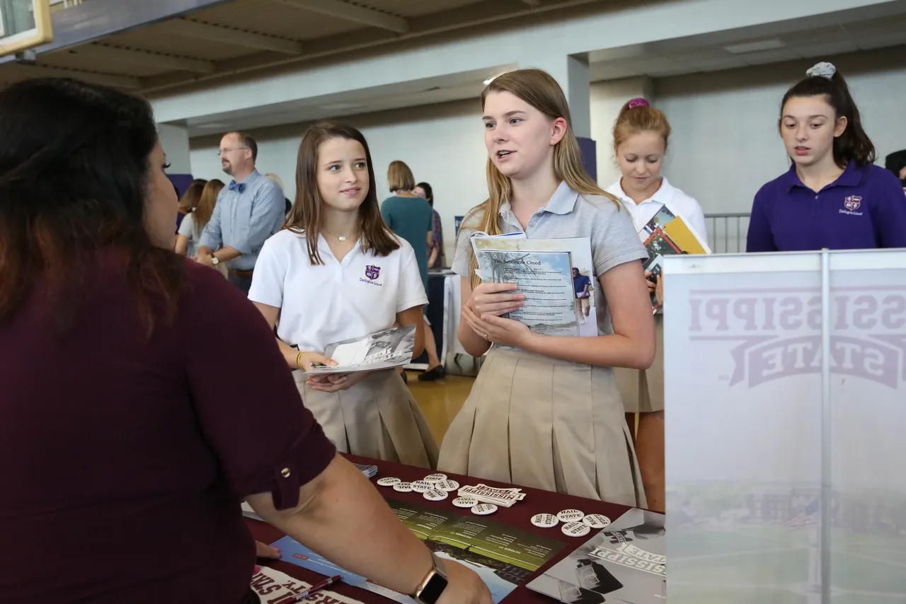 Sophomore Tanya Maples and senior Kathryn Chunn meet with representatives from Mississippi State University during Darlington's annual College Fair.