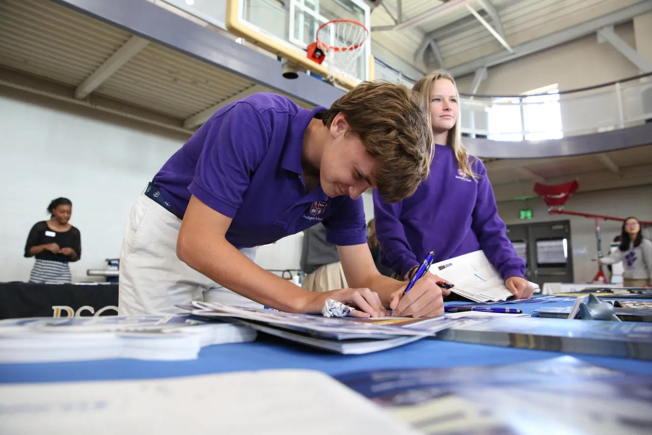 Landon Liddle ('22) and Zoe Anderson ('22) meet with college representatives during Darlington's College Fair.