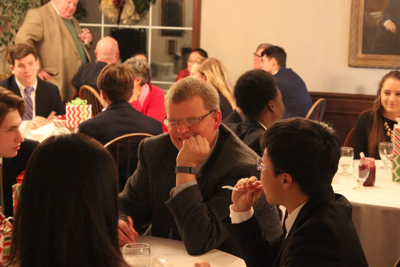 Head of House Doug Hamil visits with students during dinner.