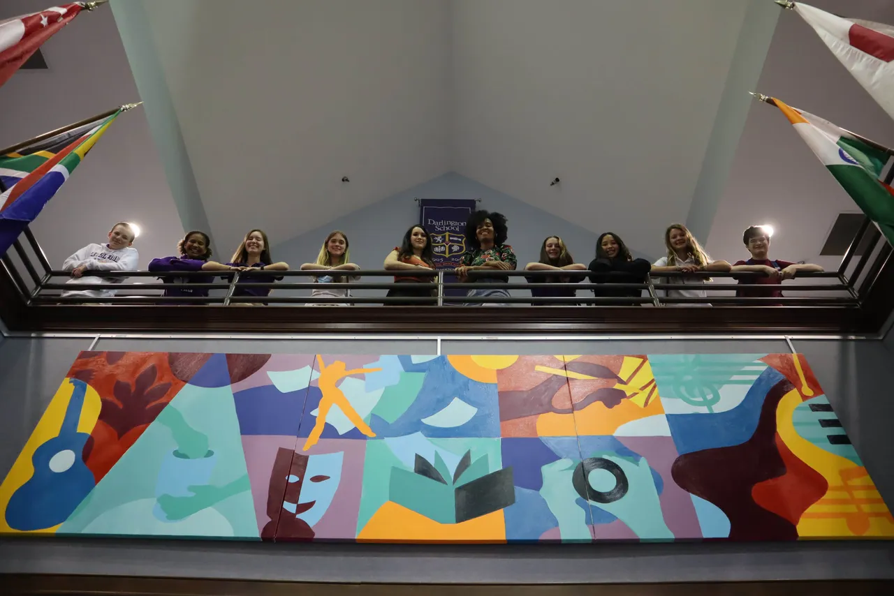Ellie Borromeo and Xaivier Ringer ('04) with students who worked on the mural at Darlington.