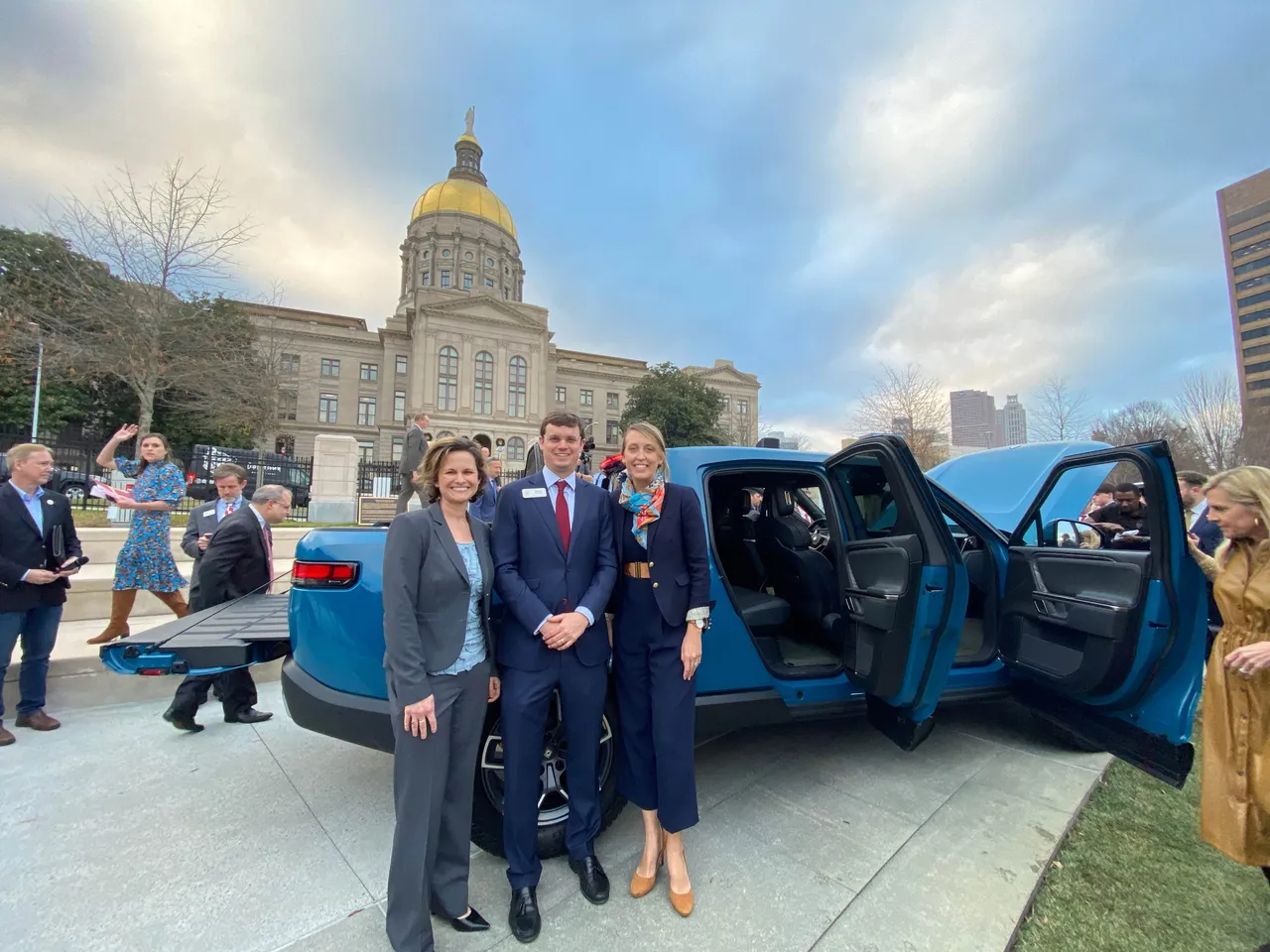 Marie (Hodge) Gordon ('99, LD '12), Barton Lowrey ('05, LD '14), and Kristi (Buice) Brigman ('05) are pictured together at the Rivian announcement event at the Georgia State Capitol.
