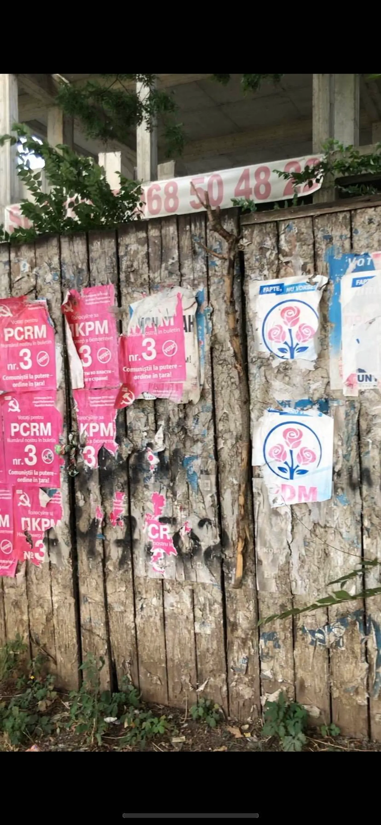 Political campaign posters for government officials of opposing parties. Many are corrupt.
