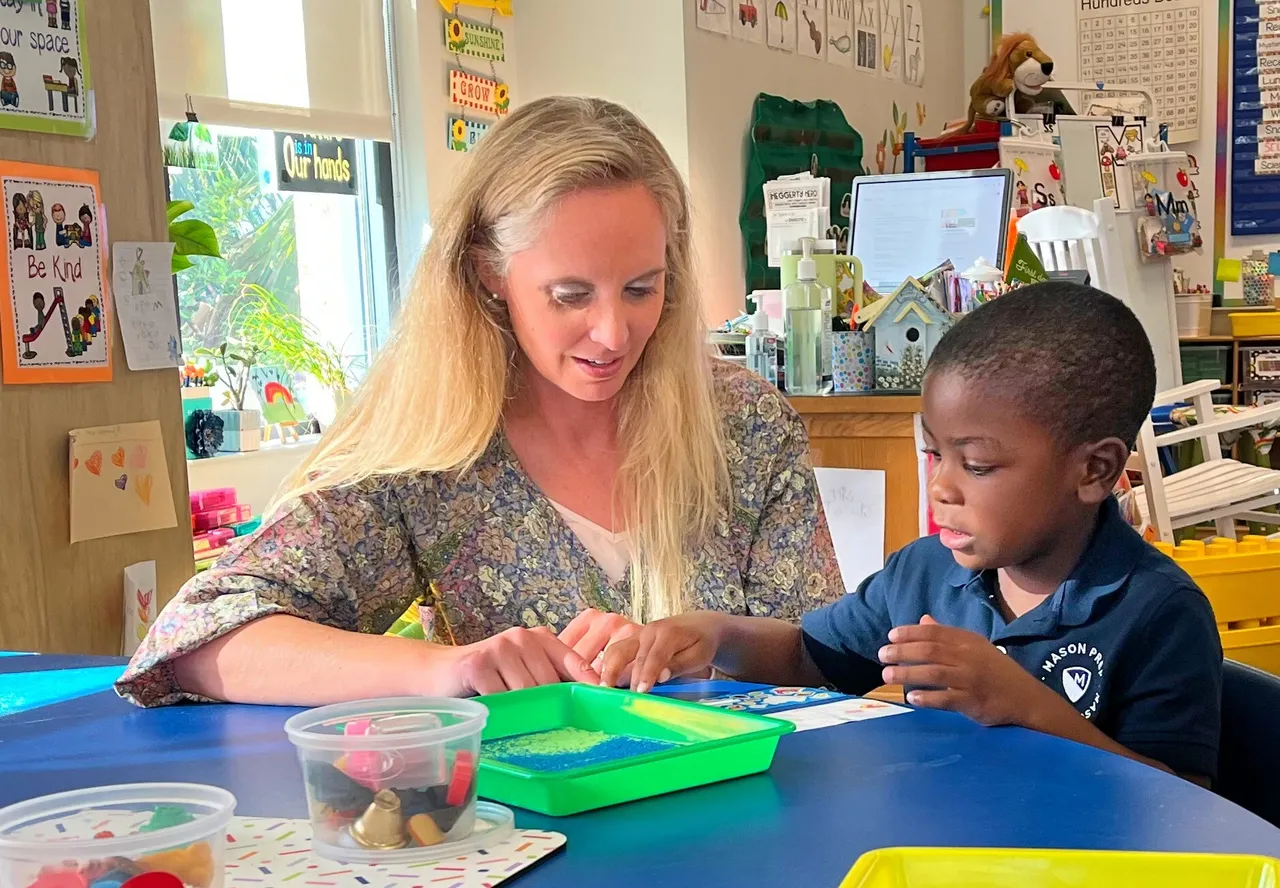 Mason Prep teacher working with a young student in the classroom