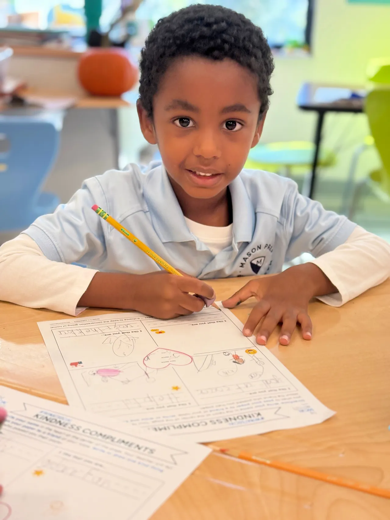 Young Mason Prep student at the table practicing writing
